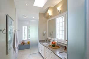 New master bathroom features a double sink, skylight and large shower