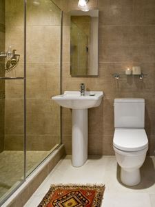 A pedestal sink saves space in a small master bathroom