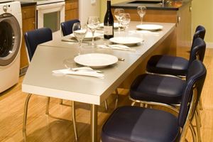 A custom drop leaf table provides a unique dining space in a once cramped kitchen