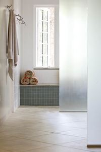 A window seat and curbless shower provides stylish functionality for homeowners wishing to age in place