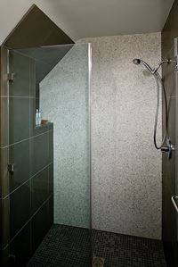 Glass enclosures instead of shower curtains visually enhance space in a small bathroom