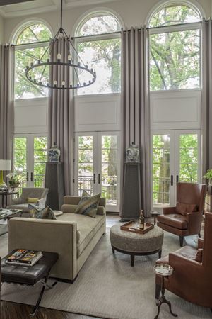 large living area with floor to ceiling windows and french doors