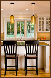 updated kitchen island with two black stools facing the kitchen sink
