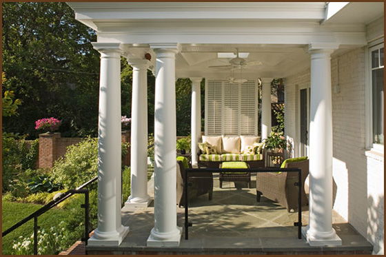 porch design with large greek columns and ceiling fan