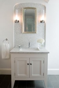 updated bathroom with a white vanity and white and grey backsplash 