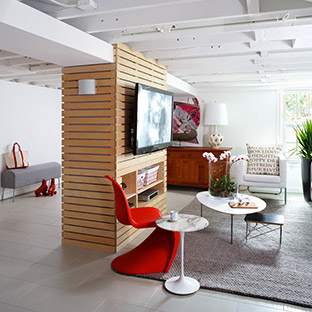 modern living room with a tv and brigh red chairs