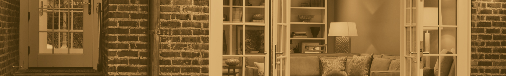 a chair sitting in front of a window next to a lamp