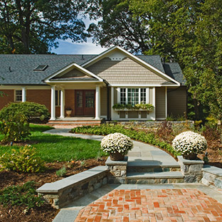 One story brick home with path leading to front door