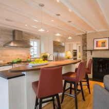 modern kitchen island with red bar stools