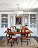 brown wood table with four chairs in a white dining room