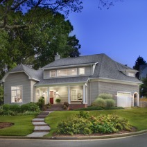 grey home with beautiful front landscaping