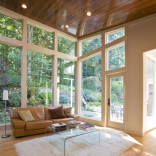 updated living area with floor to ceiling glass windows and a wooden ceiling