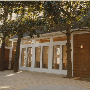 backyard deck with three sets of french doors