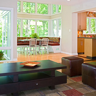 living area with white walls and warm furniture