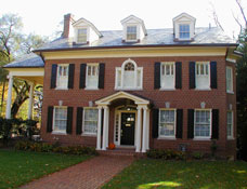 A colonial styled three-story brick home.