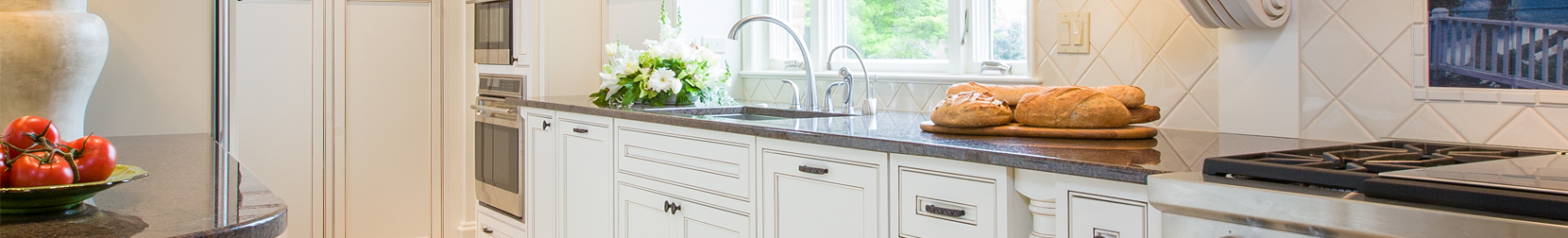 modern kitchen with black countertops and white cabinets