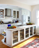 white kitchen island with glass cabinet doors