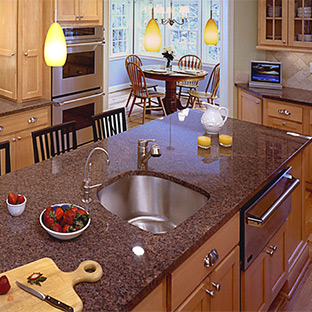 kitchen with chestnut cabinets and dark tan and black countertops