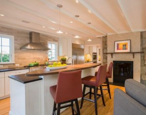 updated kitchen by Wentworth with white cabinets and black countertops