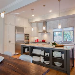 updated white kitchen with a black moody center island