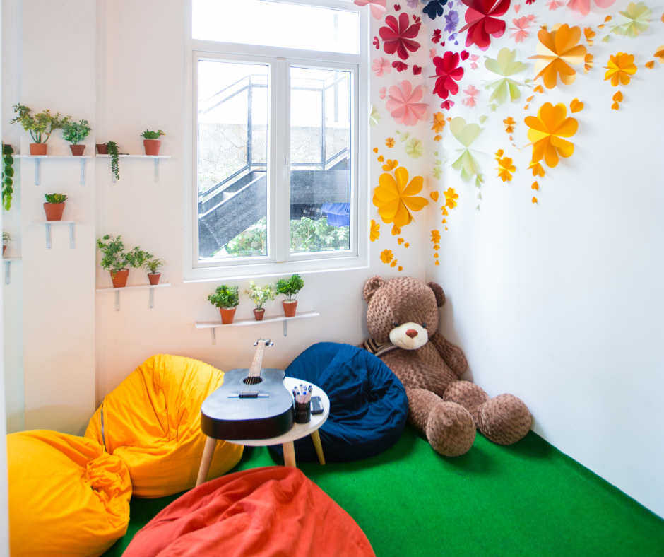 A giant teddy bear and several bean bags make up a kids' room corner 