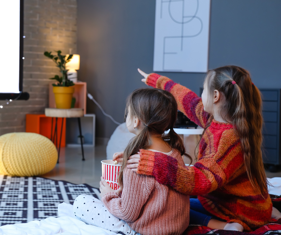 Kids watching a movie on a projector 