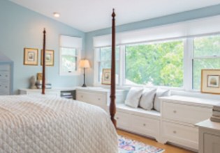 Interior of a recently remodeled room with white and light blue design and a large picture window