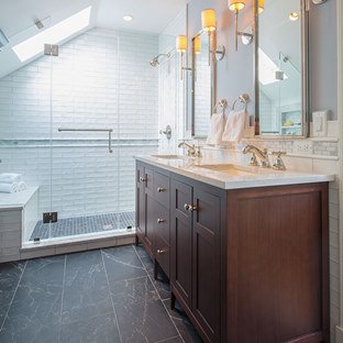 bathroom with dark wood vanity and black tile floors