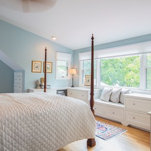 light blue bedroom with white furniture and comforter