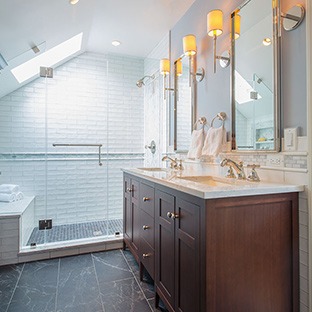 bathroom with dark wood vanity and black tile floors