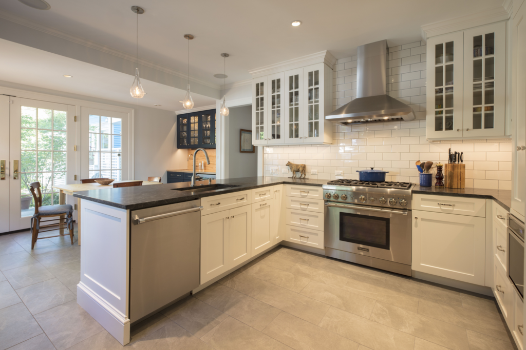 updated kitchen by Wentworth with white cabinets and black countertops