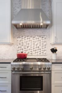 modern stainless steel gas stove with vent hood
