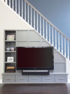 tv mounted on a blue textured wall of the staircase