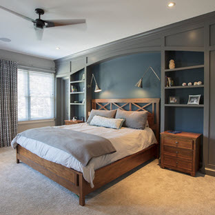 moody navy bedroom with custom built-ins and bed headboard
