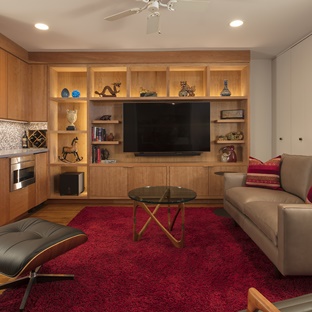 natural wood custom built-ins with moody bright red area rug