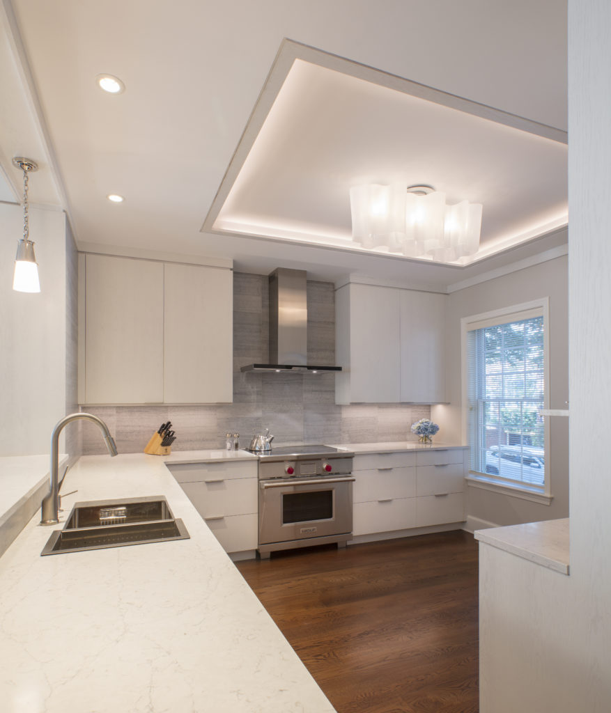 Newly remodeled kitchen with hardwood floors and silver appliances in Georgetown, DC home by Wentworth Studios