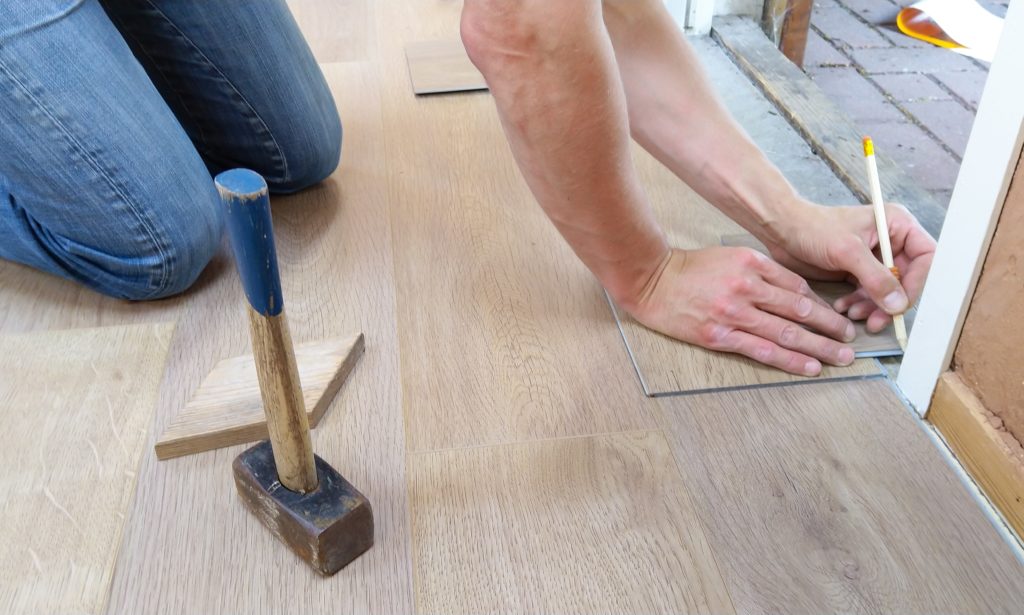 Remodeling contractor installing new floors.