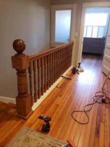hallway remodeling process with wooden banister