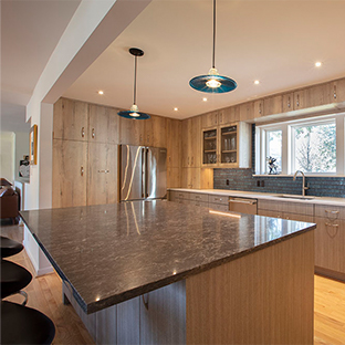 natural wood cabinets and black countertops