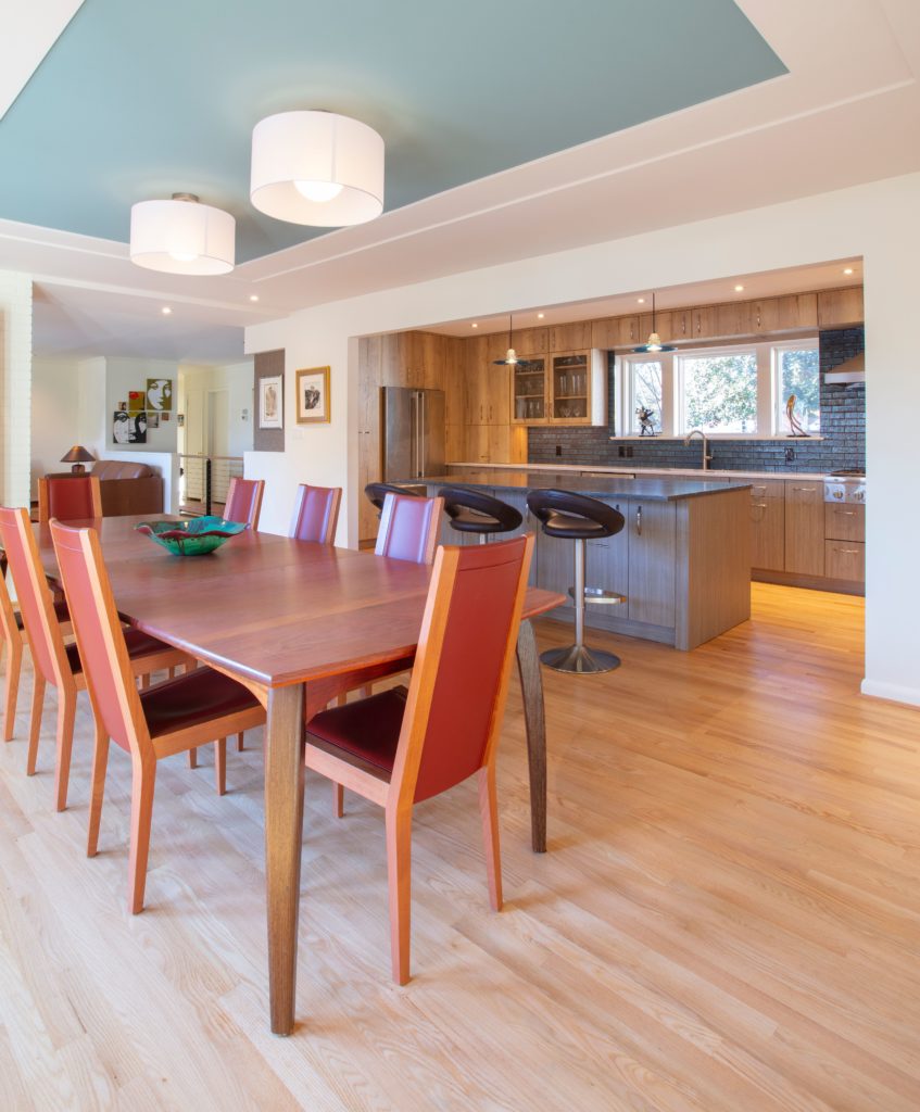 kitchen table with dark wood and eight red chairs