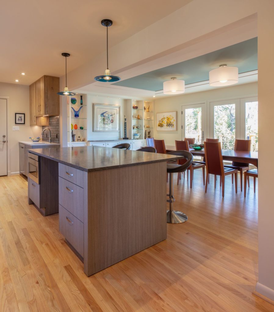 kitchen with light wood cabinets and green brick backsplash