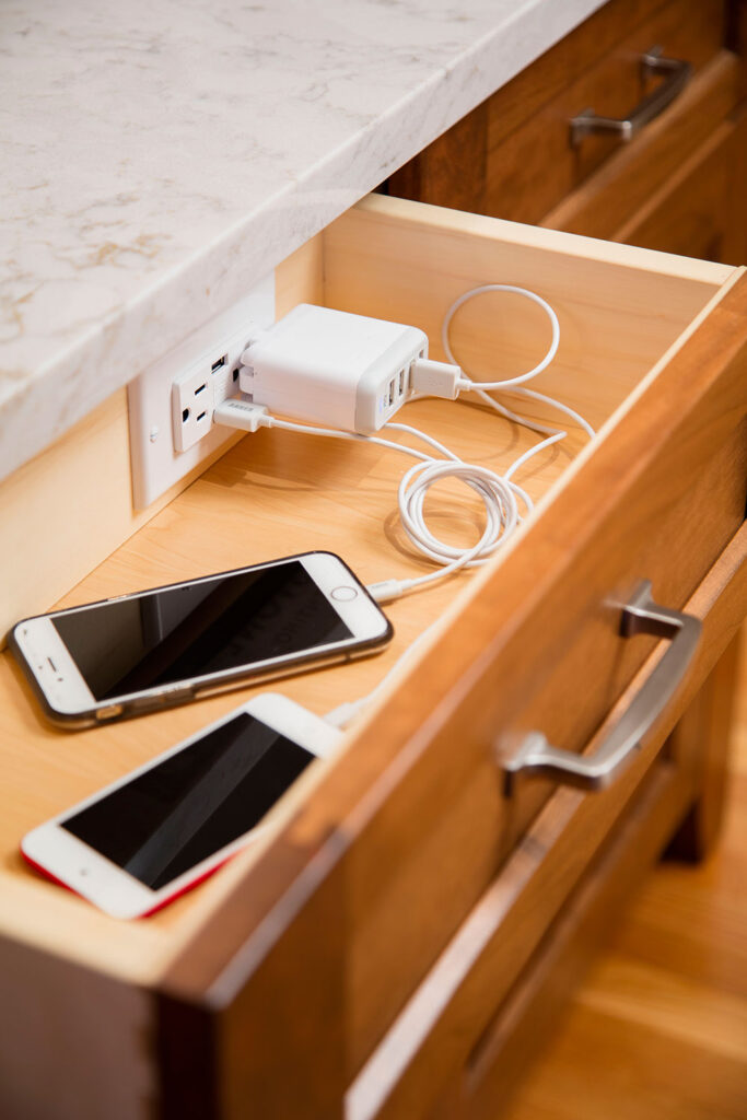 Drawer with hidden plug for phone chargers