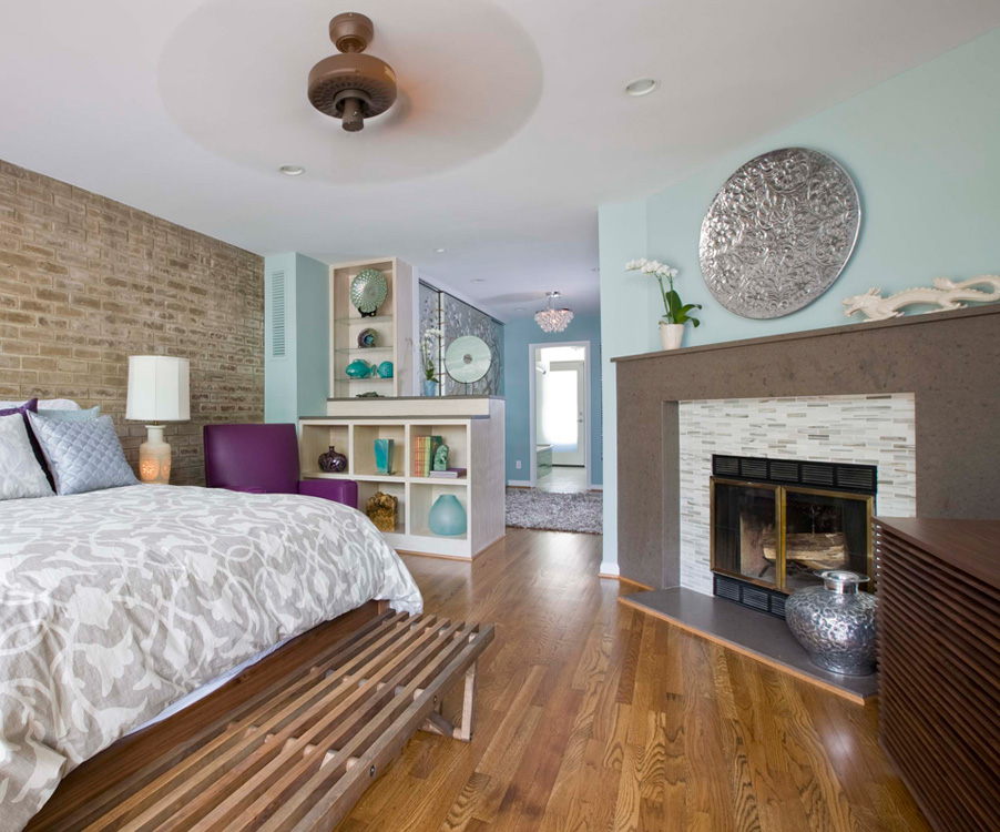 Bedroom remodel with stone walls and fireplace
