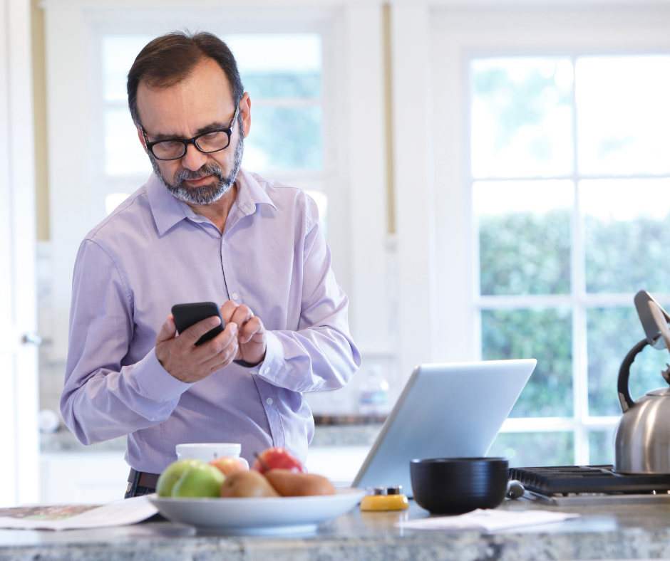 A man works from home on a kitchen island 